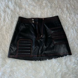 I.AM.GIA leather moto skirt with red stitching and zipper.